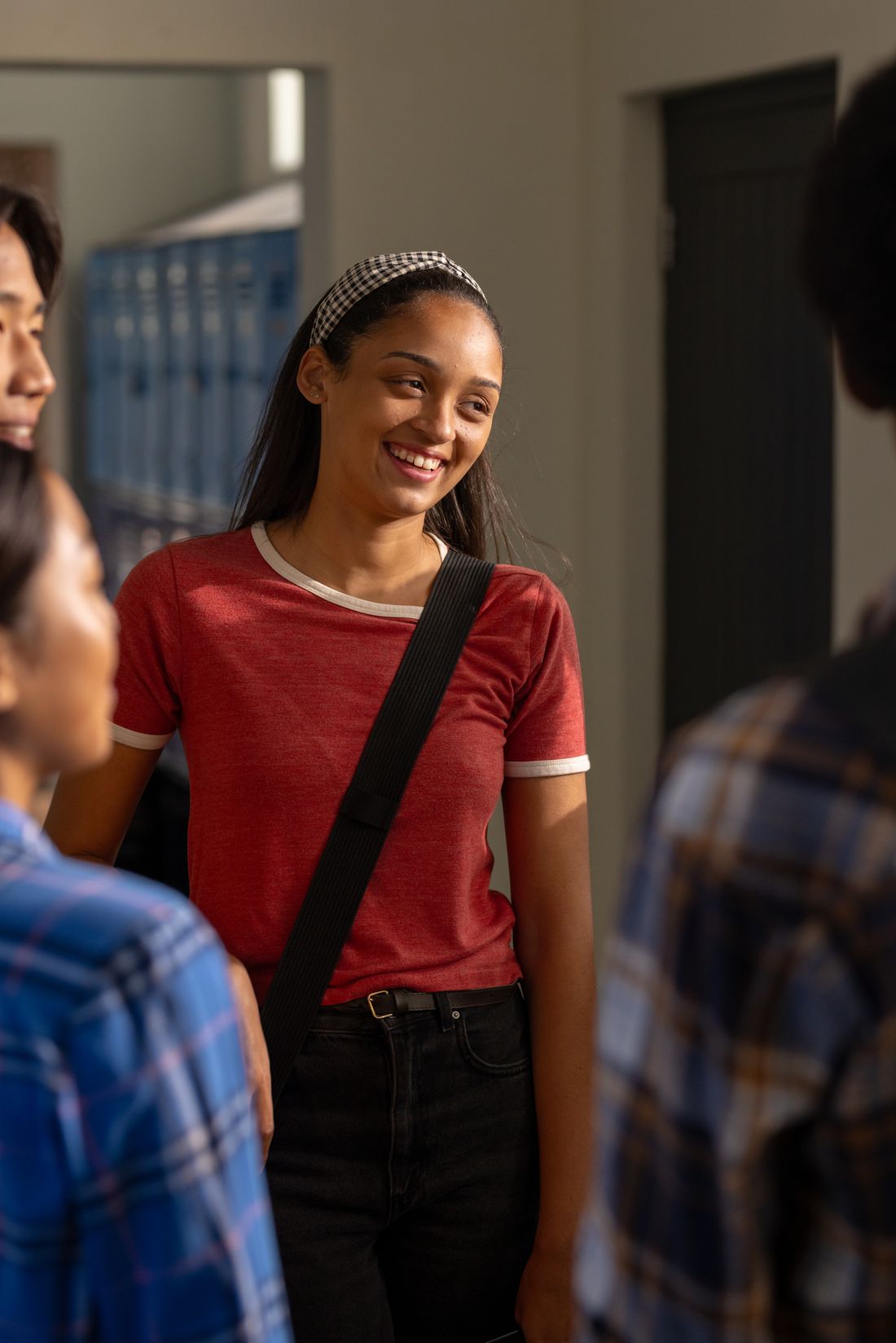 A student smiling while talking with a friend