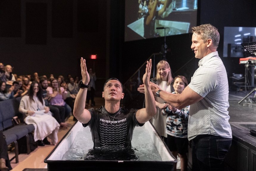 A young person being baptized during a TAF gathering
