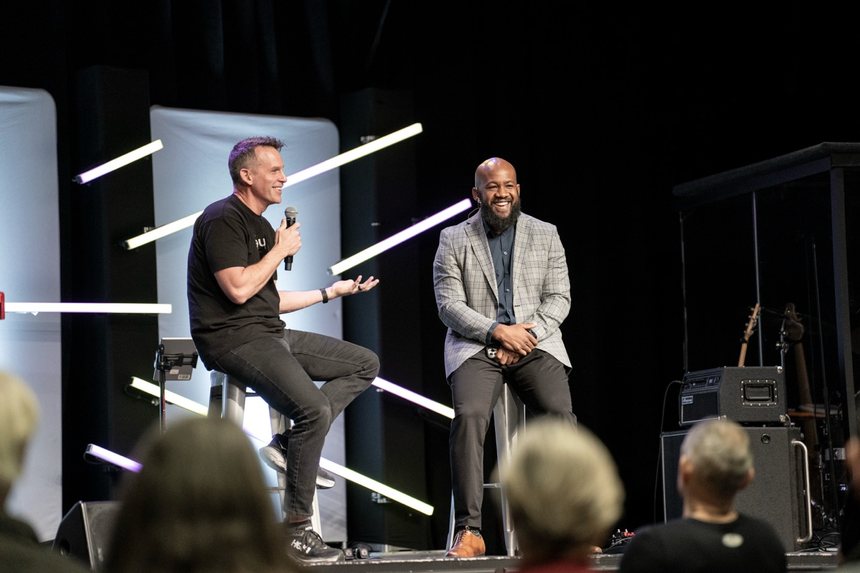 A TAF speaker in conversation with a guest on stage