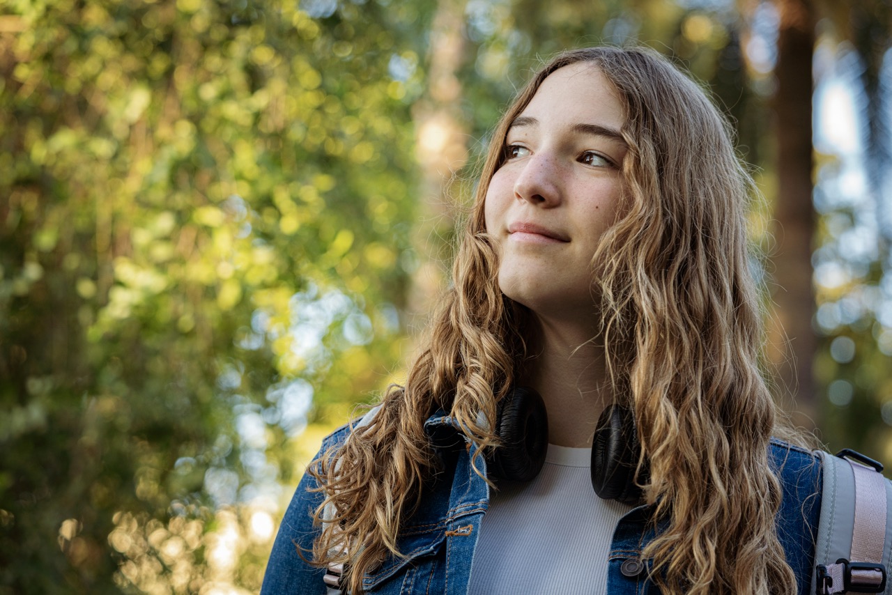 A young woman pausing in thought outdoors