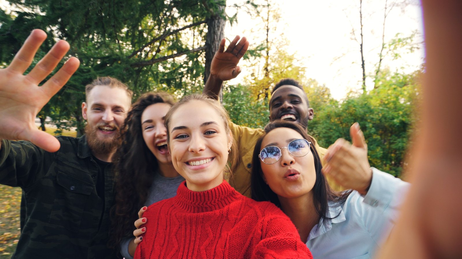 Happy university students smiling together outdoors